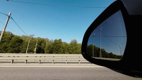 Modern car on highway. Window view with the mirror 