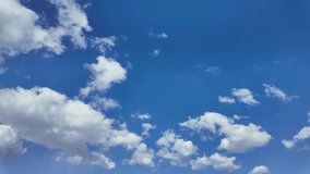 Blue sky white clouds. Puffy fluffy white clouds. cloud clouds time lapse. Summer blue sky time lapse. Nature weather blue sky. White clouds background. Cloud time lapse , video loop
