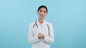 Happy female doctor conducting online consultation over blue background