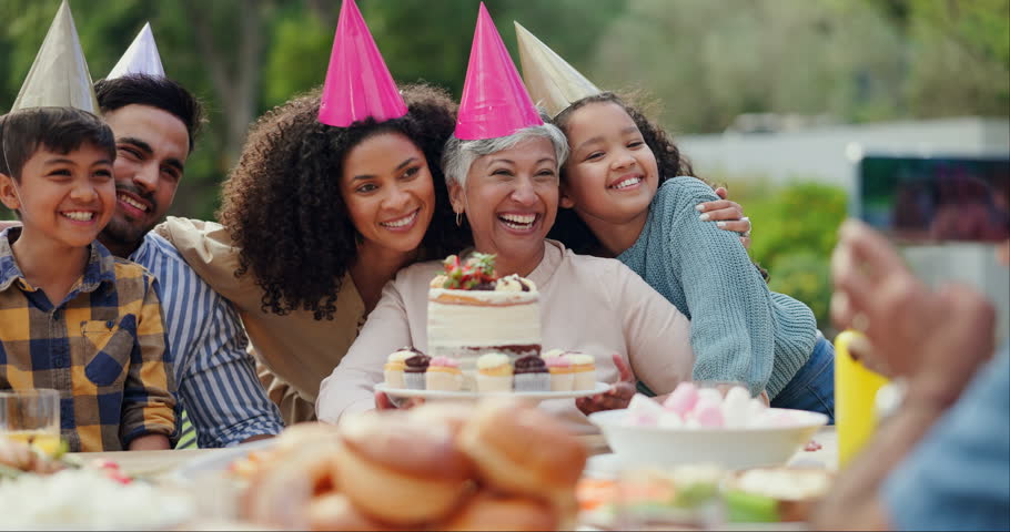 Family, birthday party and people taking photograph outdoor, happiness and celebration with cake. Photography, parents with grandmother and kids in backyard, social event and dessert with festive hat