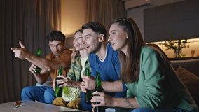 Smiling buddies watching movie at night home couch. Happy relaxed friends holding beer bottles looking television show together. Joyful youngsters enjoying evening viewing tv at weekend gathering. - Powered by Shutterstock - Get 15% off with code: PIKWIZARD15