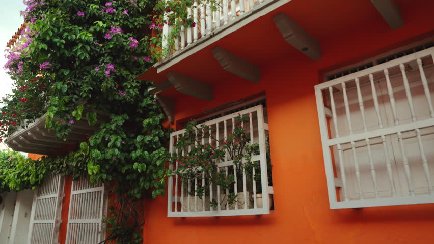Cartagena de las Indias old town in Colombia. View of the vibrant colorful facades decorated with vibrant flowers. Spanish colonial historic district.
