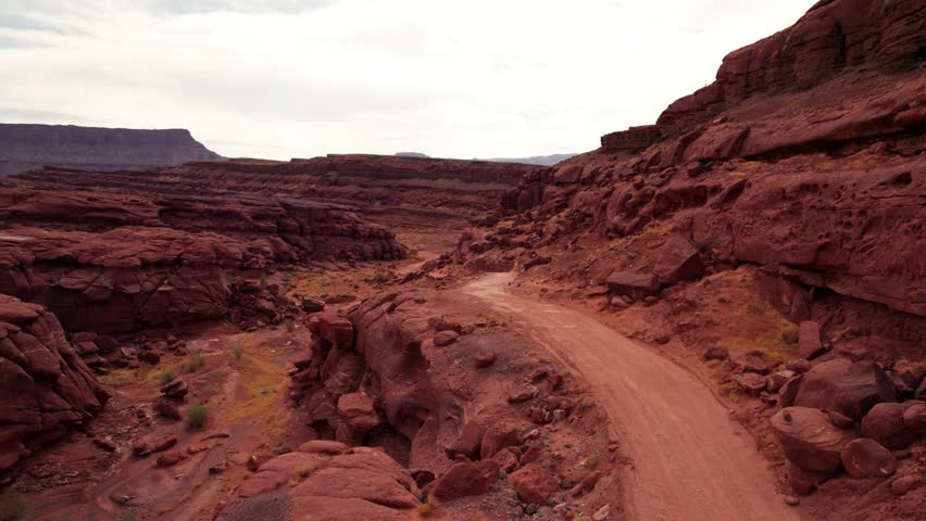 Drone shot flying down an off road trail in Moab, Utah in the fall Royalty-Free Stock Footage #3434180585