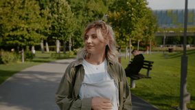 Happy future mom keeping an active lifestyle while pregnant. Loving pregnant woman touching her baby bump while on a walk. Pregnancy and maternity concept. - Powered by Shutterstock - Get 15% off with code: PIKWIZARD15