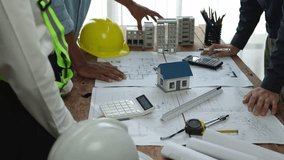 Team of engineers meeting holding worker helmets in city construction office Industrial Project Manager Foreman Engineer meeting to work as a team Professional team in Asian industry. - Powered by Shutterstock - Get 15% off with code: PIKWIZARD15