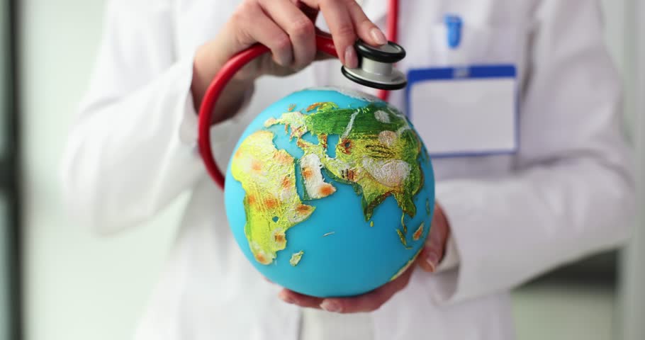 Doctor places stethoscope on Earth model. Woman listens to globe representing Earth emphasising crucial need for planetary care slow motion Royalty-Free Stock Footage #3434219583