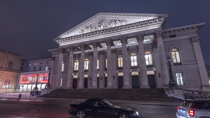 Hyperlapse: Munich National Theatre or Nationaltheater on the Max Joseph square night timelapse hyperlapse. Illuminated historic opera house front view, home of the Bavarian State Opera. Germany Royalty-Free Stock Footage #3434265117