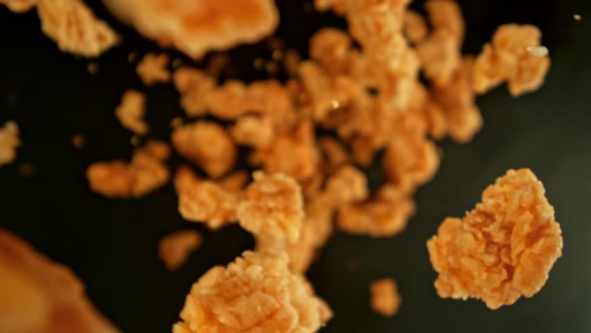 Super Slow Motion Shot of Flying Fried Chicken Pieces Towards Camera at 1000fps. Royalty-Free Stock Footage #3434313155