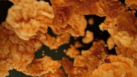Super Slow Motion Shot of Flying Fried Chicken Pieces Towards Camera at 1000fps. Adlı Stok Video