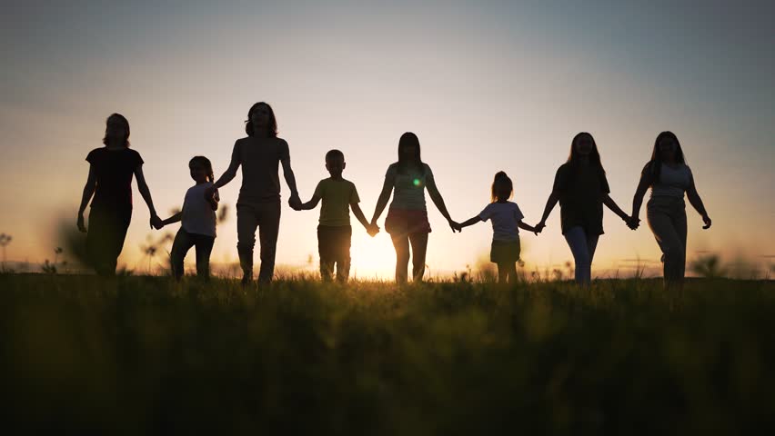 Happy big family. group of people walk together in park at sunset. large family walk together holding hand in park. Family walk together for picnic outdoors in park. Large family team outdoors in park Royalty-Free Stock Footage #3434379045