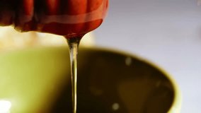 Fresh honey drizzles from wooden honey dipper spoon close up macro 4k shot selective focus - Powered by Shutterstock - Get 15% off with code: PIKWIZARD15