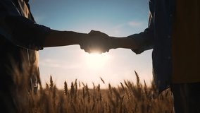 Farmers handshake against backdrop of wheat field.way to success.reaching agreement in agricultural business.farmers handshake in wheat field.reaching goal with handshake.agriculture business concept - Powered by Shutterstock - Get 15% off with code: PIKWIZARD15