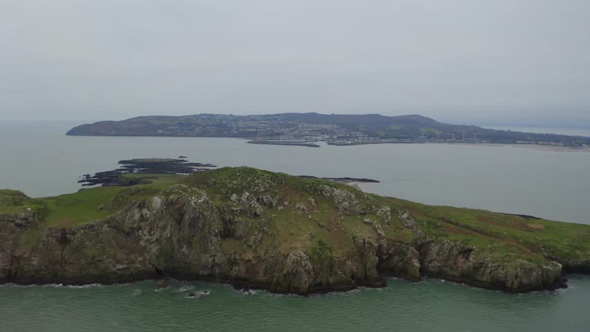 Cinematic tracking shot showcases Ireland's Eye cliffs, flying over. Howth in background Royalty-Free Stock Footage #3434445805