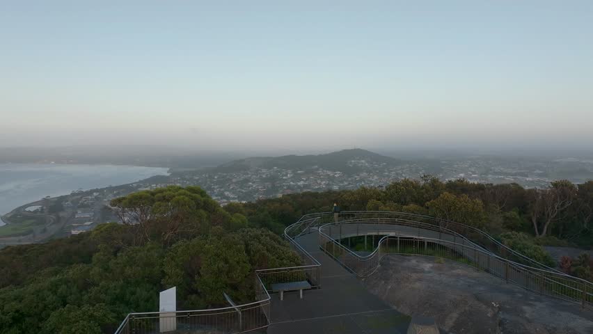 Slow push in over the viewing platform of Mt Clarence with the city of Albany sprawling out below near the beach at sunrise.