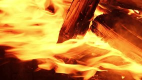 Fireplace. Beautiful slow motion of vivid fire flame over wooden logs. Cozy relaxing background TV Screen Saver. Fireplace with Flames Christmas Holidays Concept. Video for Meditation Vertical video