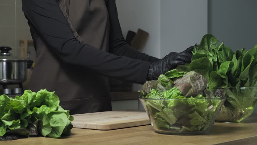Green lettuce of cabbage leaves, lactuca sativa and spinach leaves. Concept of healthy nutrition, healthy food, lifestyle, diet, vegetarian meal, organic food. Making green salad, cooking with greens Royalty-Free Stock Footage #3434458601