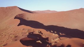 4K high quality aerial video drone footage of famous endless sand sea and Sossusvlei Namib Desert scenic red sand dunes on sunny morning in Namib-Naulkuft Park in Namibia, southern Africa