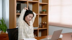 Asian women sitting working, aches pains body due sitting working in same position for many hours, so move body, sit massage body, doing poses relieve aches pains according clip on laptop computer.