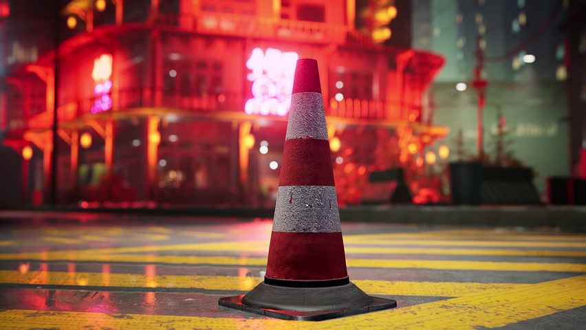 A red and white traffic cone on the side of a road Royalty-Free Stock Footage #3434566347