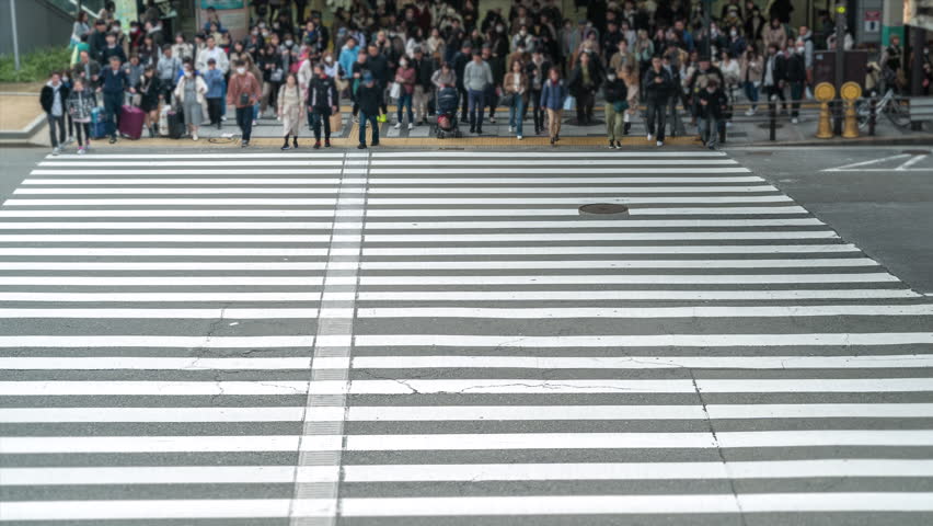 Timelapse view of crowded zebra crossing in the Umeda district of Osaka, Japan, city life, business and finance concept. Royalty-Free Stock Footage #3434661545
