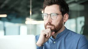 Thoughtful confident businessman works on laptop sitting at workplace in business office. Handsome entrepreneur is busy with startup project on computer or thinking about solving problem. Close up - Powered by Shutterstock - Get 15% off with code: PIKWIZARD15