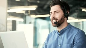 Confident operator who works in customer support speaks on a video call using a laptop. Call center agent in wireless headset helping customer with complaints in office. Online consultation. Close up - Powered by Shutterstock - Get 15% off with code: PIKWIZARD15