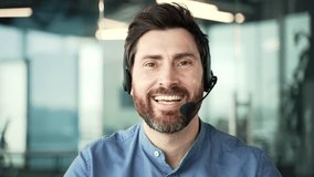 Webcam view. Businessman in headset talking on a video call looking at the camera sitting in office. Entrepreneur has a business meeting. Call center agent helping customers with complaints. Close up - Powered by Shutterstock - Get 15% off with code: PIKWIZARD15