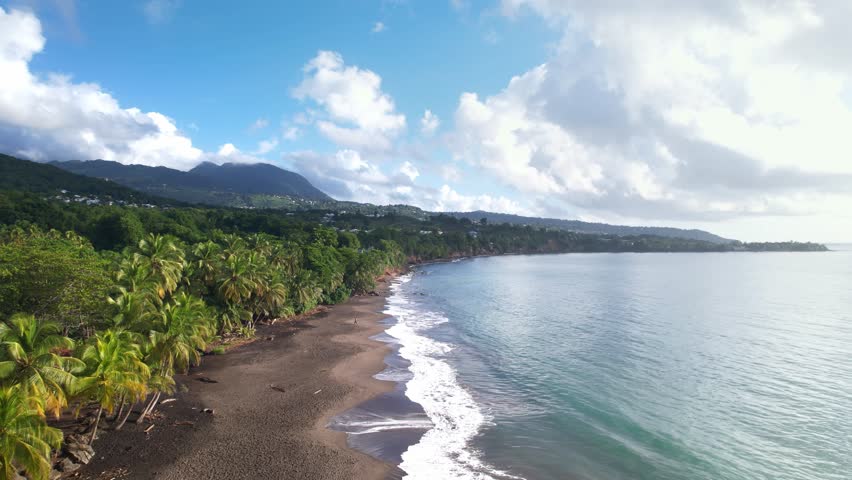 Plage de Grande Anse, pristine beach in Guadeloupe, French Antilles. Aerial forward 