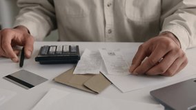 Indian Arabian man guy businessman using calculator and laptop calculate costs income money counting bills office paperwork check expenses write business budget smiling male accountant financial work - Powered by Shutterstock - Get 15% off with code: PIKWIZARD15