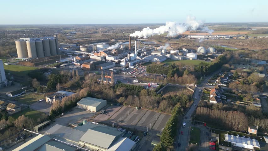 industrial complex and smokestacks, clear day, aerial view