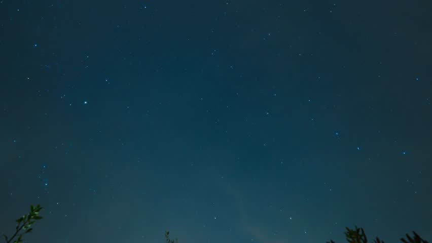Star trail of stars moving in the night sky around the North Star. Landscape with movement of stars in the Tuscan country, time lapse