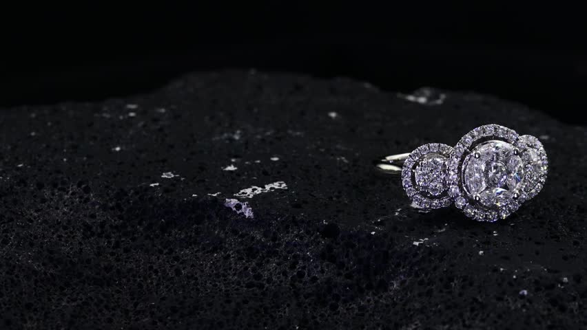 beautiful diamond ring on black rock with balck background