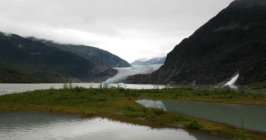 Mendenhall Glacier and Lake, with Nugget Falls on the right. Stroller White Mountain covered by clouds on the left, Alaska