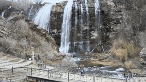 man travel waterfall. High quality 4k footage