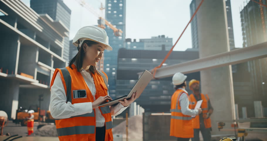 Asian Female Architect Working as a Civil Engineer. Young Japanese Woman Using Computer Software for Planning, Designing and Constructing a Commercial Real Estate Building in the Heart of the City