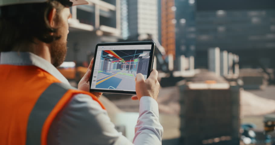 Industrial Engineer Inspecting a Residential Construction Spot with a Virtual Reality App with a Virtualization of the Building's Interior. Over the Shoulder Footage of an Architect Working on Site