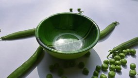 Green pea on white background. There is a lot of vitamins  and Minerals in it. The pea is most commonly the small spherical seed or the seed. Popular vegetable of all over world. Slow motion video. 