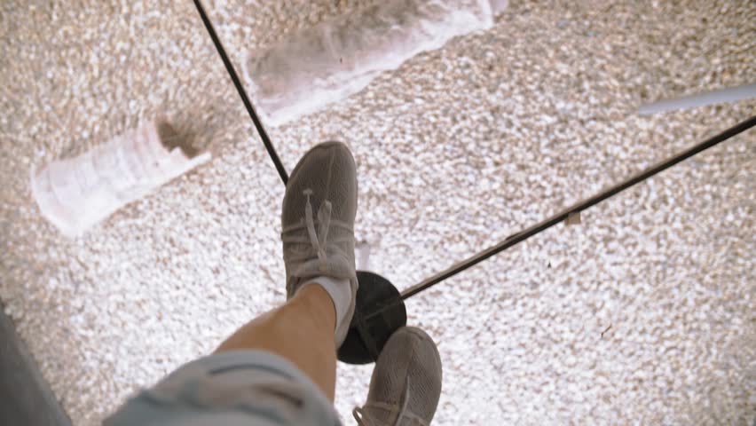 First point view. Museum of archaeological excavations under glass. Historical artifacts. Top view of a tourist's feet walking on a sturdy glass surface. Royalty-Free Stock Footage #3435002523