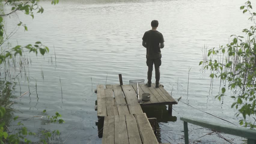 Guy fishing with a spinning rod.
