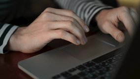 A man with long, dirty fingernails uses the touchpad of a laptop. Serene Workspace for Modern Creatives in Traditional Setting - Powered by Shutterstock - Get 15% off with code: PIKWIZARD15