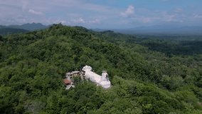 Aerial view of the white building is very striking because of the dense trees. 