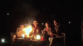 Happy Group of asian people friend party camping in nature making toasting with soft drink and beer red cup at night. Hangout party outdoor in campsite nature forest on holiday weekend vacation. - Powered by Shutterstock - Get 15% off with code: PIKWIZARD15