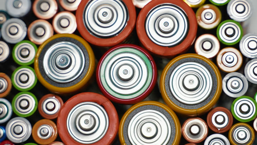 Rows of used alkaline AA, AAA, D batteries. Lithium ion battery pack close up