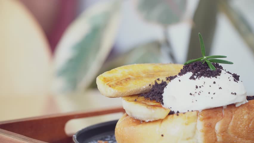 Delicious honey ice cream atop toasted bread in cafe.