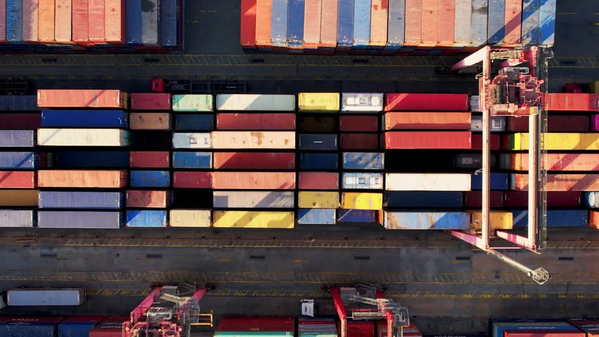 Cargo containers top aerial view. Containers at logistics terminal. Cargo import and export port and is part of a shipping dock. 