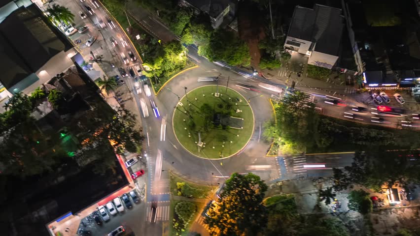 Aerial Fast Orbit Hyperlapse of Roundabout Traffic at Night. Ciudad Jardin. Cali, Colombia