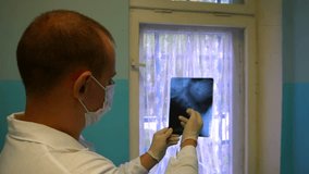 Doctor examining X-ray searching diagnosis. Doctor hand pointing on x-ray image. - Powered by Shutterstock - Get 15% off with code: PIKWIZARD15