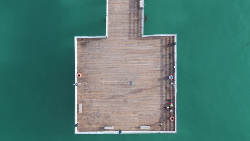 Aerial View of southern california pier with a beautful orange sunset