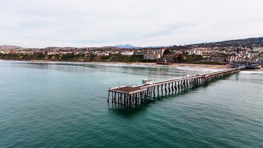 Aerial View of southern california pier with a beautful orange sunset