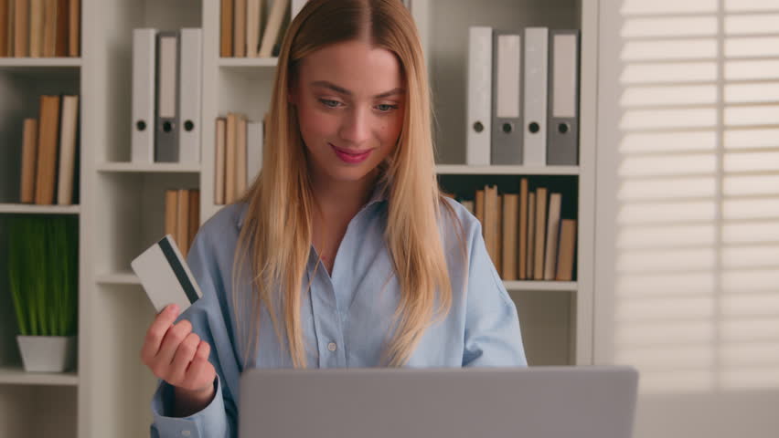 Happy Caucasian woman using bank credit card laptop for online shopping payments at home office business transaction. Smiling girl customer shopper client purchase with computer E-banking app service Royalty-Free Stock Footage #3435209253